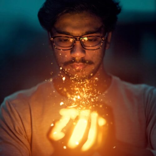 man holding lighted art
